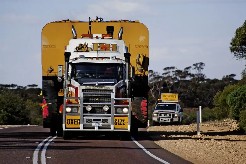 Pilot Car Following A Huge Australian transport truck